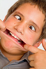 eStockPhoto Boy Hand Over Mouth Stock Photo