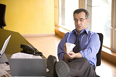 eStockPhoto Feet Under A Desk Stock Photo